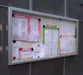 Wall hung landscape notice board with rising door